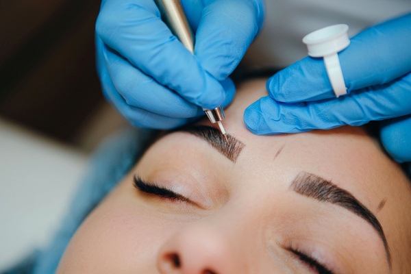 a person getting their eyebrows done in a salon
